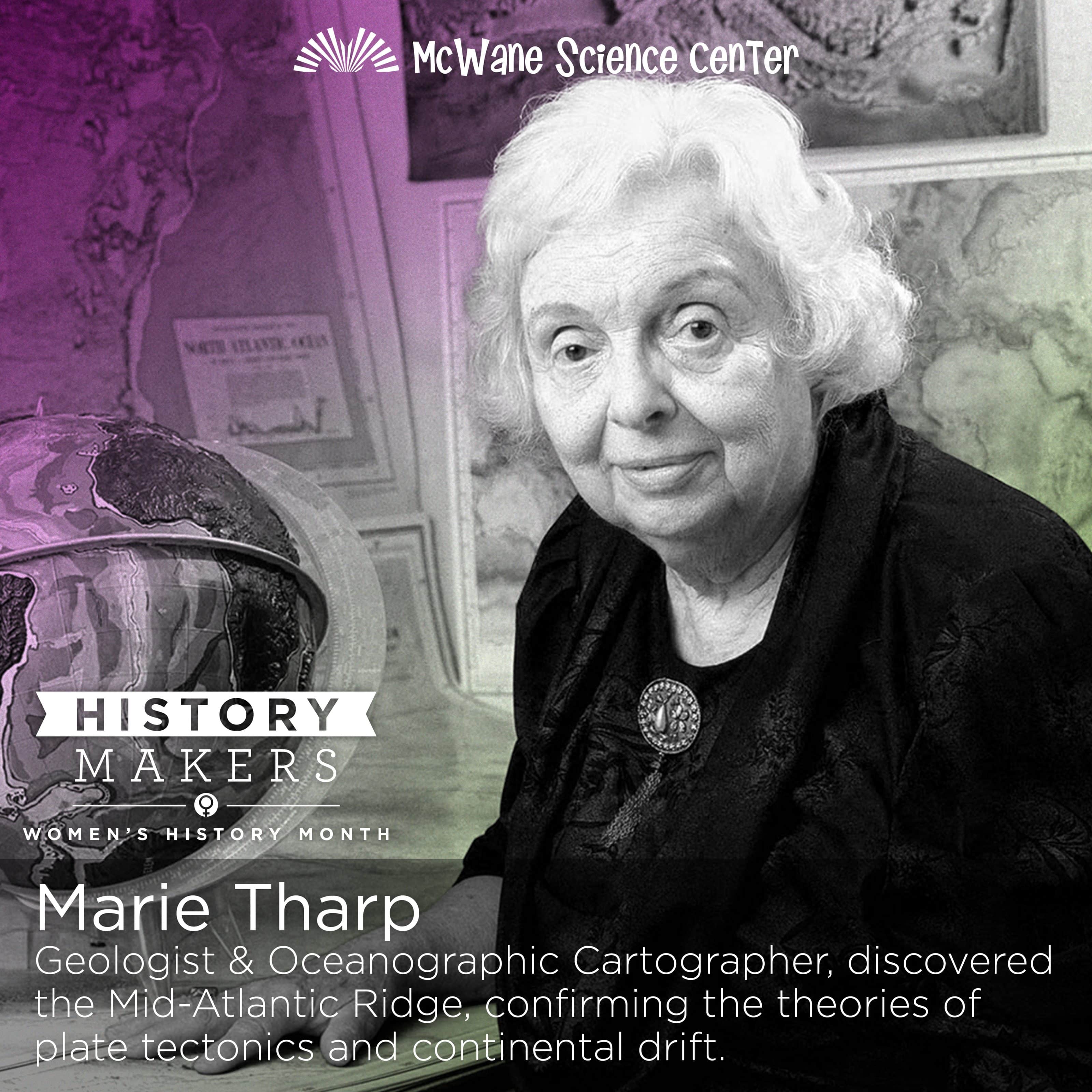 A woman scientist at McWane Science Center with globe and ocean maps, celebrating Women's History Month.