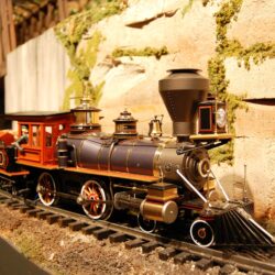 Vintage model steam locomotive on diorama tracks at children's science center train exhibit