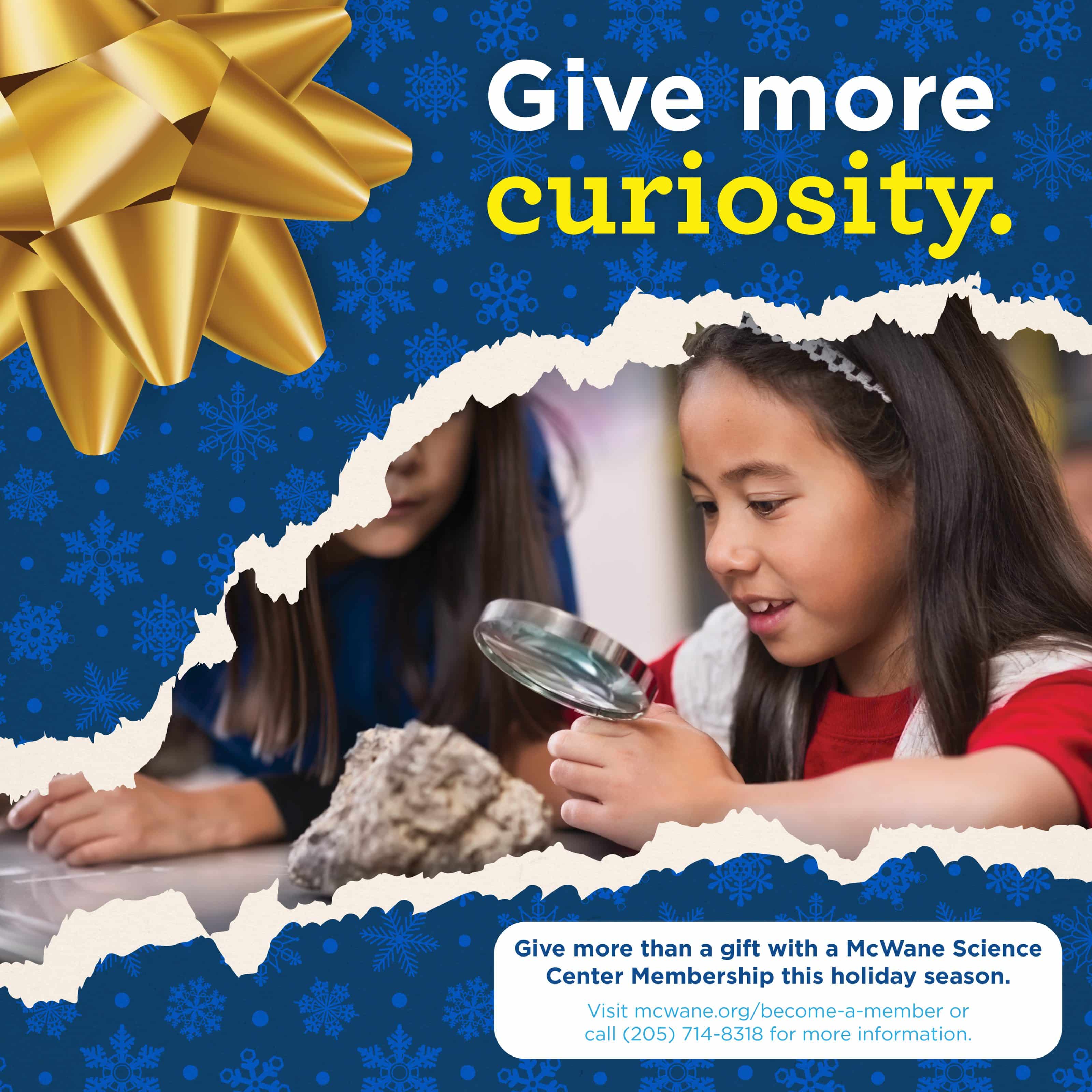 Child explores a rock with a magnifying glass at McWane Science Center; Give More Curiosity holiday membership gift promo.