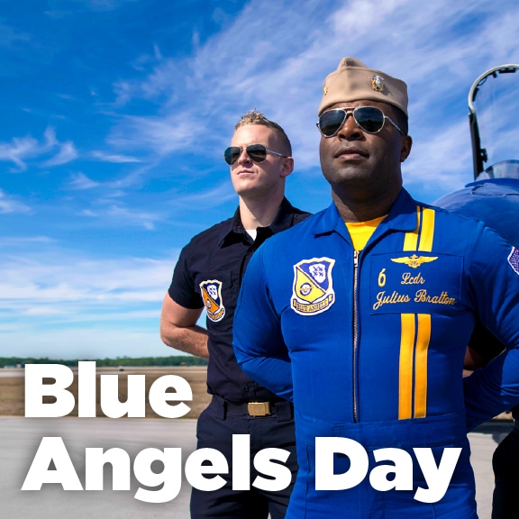 Two Blue Angels team members by a jet—Blue Angels Day at the children's science center.